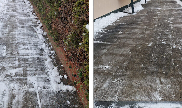 Winterdienst – verschneiter Gehweg neben einer Hecke und geräumter Weg am Gebäude